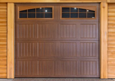 brown garage door with two arched windows