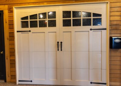 white garage door with black iron handles